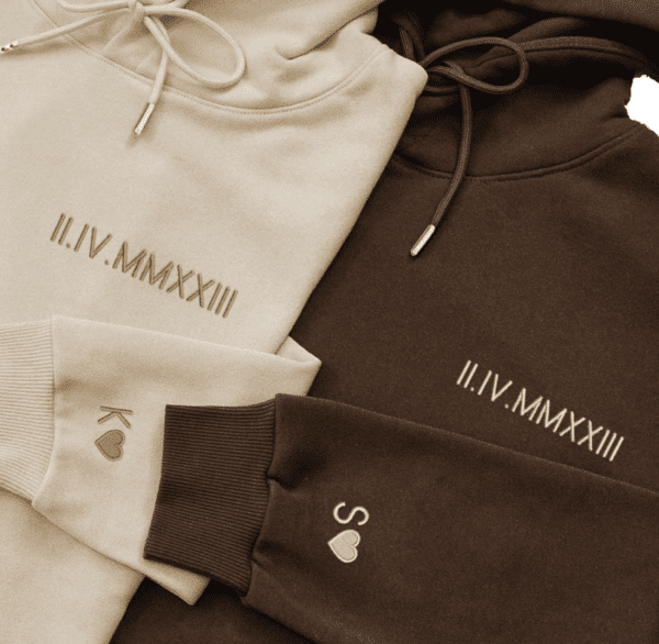 A close up of three different colored hoodies